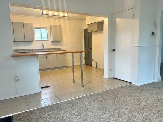 7 Fairview Pl, Union Twp Wsh, PA 15038 - kitchen with light tile patterned flooring, gray cabinets, butcher block counters, and a sink