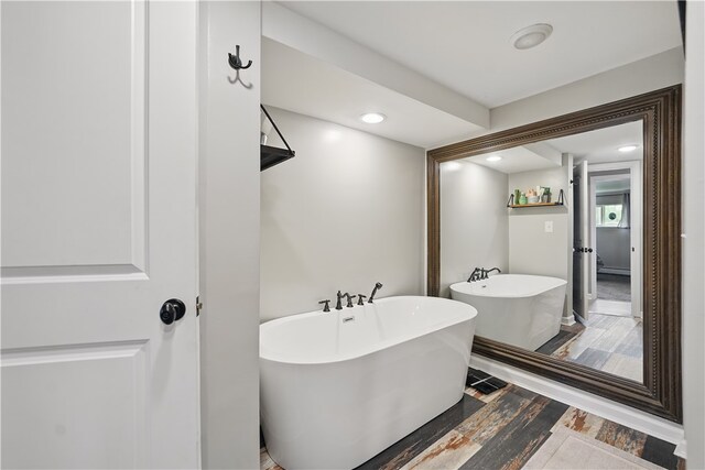 1182 W Laurel Cir, Mount Pleasant Twp, PA 15666 - bathroom featuring a soaking tub and wood finished floors