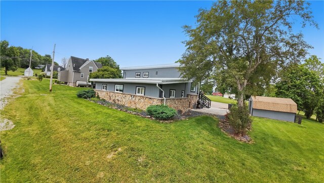 1182 W Laurel Cir, Mount Pleasant Twp, PA 15666 - rear view of house with stone siding and a yard