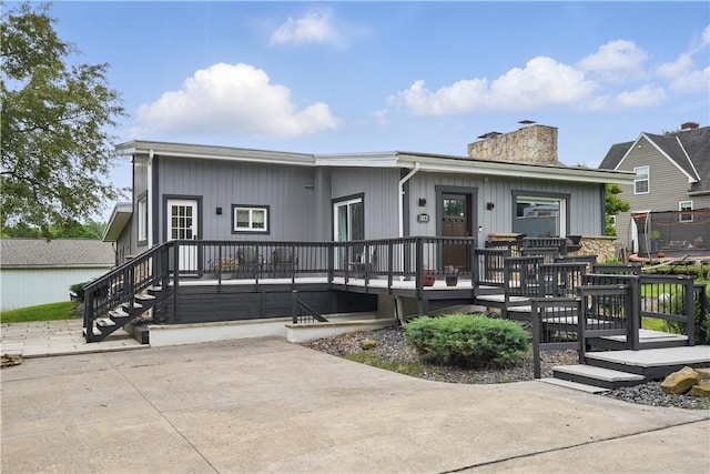 1182 W Laurel Cir, Mount Pleasant Twp, PA 15666 - view of front facade featuring a chimney and a wooden deck