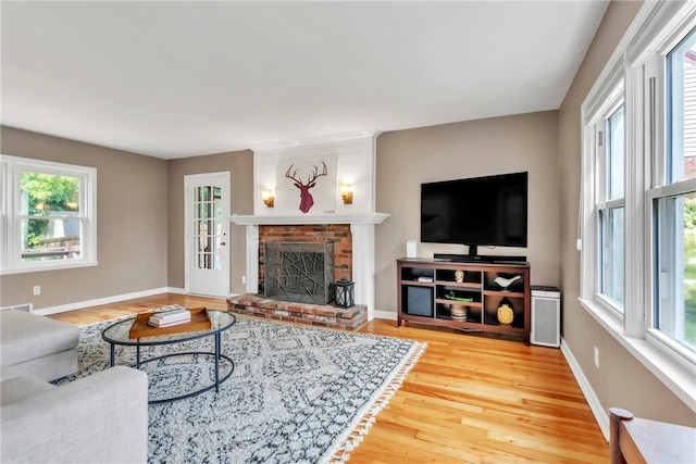 132 Crescent Hills Rd, Penn Hills, PA 15235 - living area featuring wood finished floors, healthy amount of natural light, baseboards, and a brick fireplace