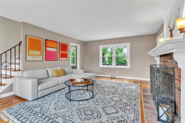 132 Crescent Hills Rd, Penn Hills, PA 15235 - living area with baseboards, wood finished floors, stairs, and a fireplace