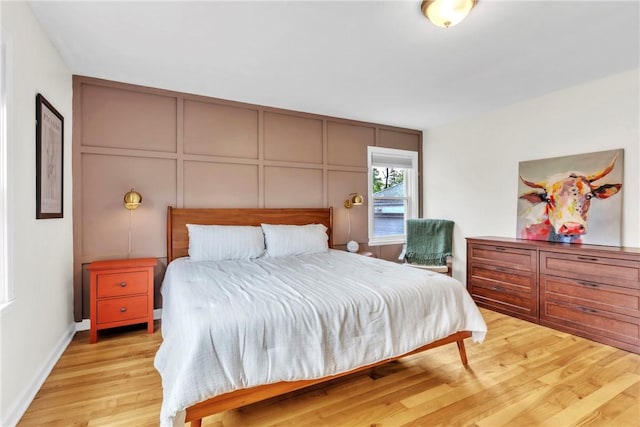 132 Crescent Hills Rd, Penn Hills, PA 15235 - bedroom with a decorative wall, wood finished floors, and baseboards