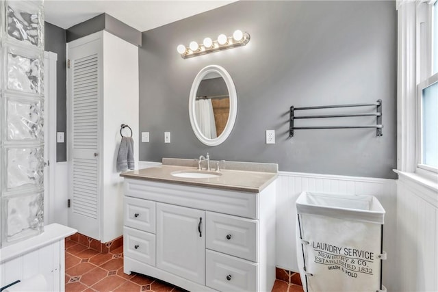 132 Crescent Hills Rd, Penn Hills, PA 15235 - bathroom with vanity, a wainscoted wall, and tile patterned floors