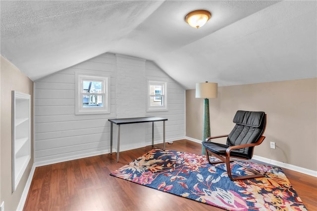 132 Crescent Hills Rd, Penn Hills, PA 15235 - sitting room featuring wood finished floors, vaulted ceiling, a textured ceiling, and baseboards