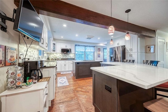 190 Ridge Ave, Mccandless, PA 15237 - kitchen with appliances with stainless steel finishes, a center island, beamed ceiling, backsplash, and white cabinetry