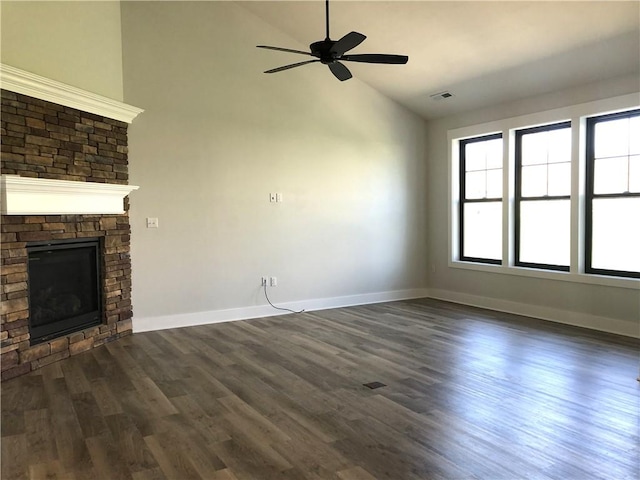 1006 Sweetgum Ct, Penn Twp Wml, PA 15644 - unfurnished living room featuring a stone fireplace, baseboards, a ceiling fan, dark wood-type flooring, and high vaulted ceiling
