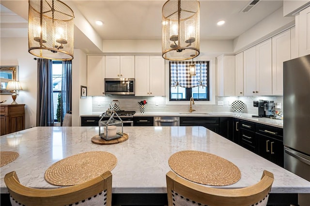 1006 Sweetgum Ct, Penn Twp Wml, PA 15644 - kitchen with a chandelier, appliances with stainless steel finishes, a sink, healthy amount of natural light, and recessed lighting