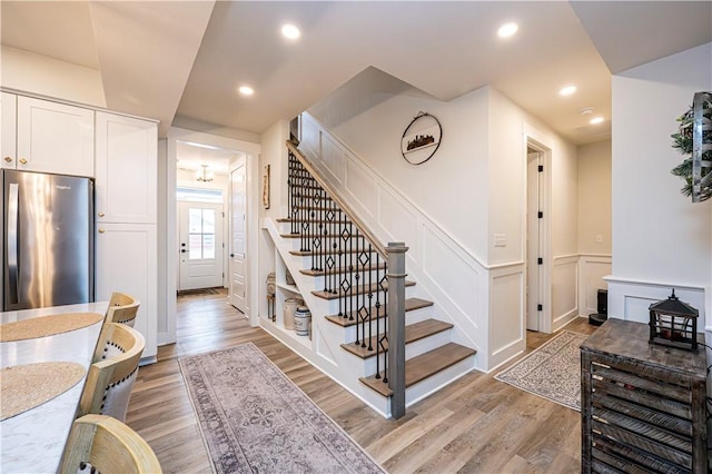 1006 Sweetgum Ct, Penn Twp Wml, PA 15644 - stairs featuring wood finished floors, wainscoting, a decorative wall, and recessed lighting