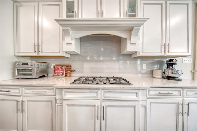 1703 Stevensan, Franklin Park, PA 15143 - kitchen featuring stainless steel gas stovetop, backsplash, white cabinetry, and glass insert cabinets