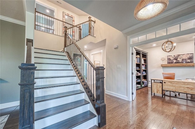 1703 Stevensan, Franklin Park, PA 15143 - stairway featuring crown molding, baseboards, wood finished floors, and a chandelier