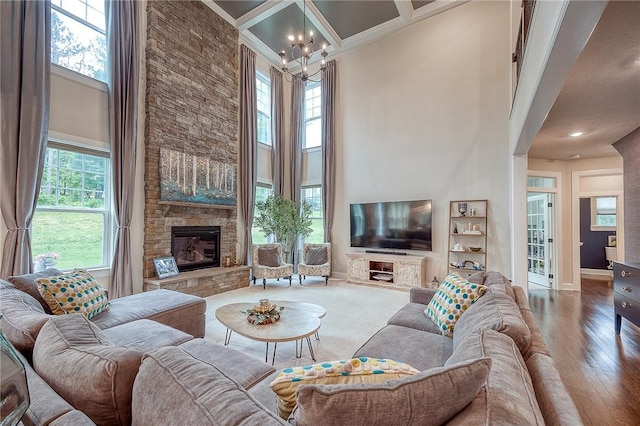 1703 Stevensan, Franklin Park, PA 15143 - living area with a chandelier, a high ceiling, a stone fireplace, wood-type flooring, and crown molding
