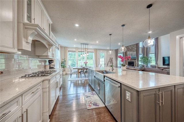 1703 Stevensan, Franklin Park, PA 15143 - kitchen with stainless steel appliances, a sink, dark wood-type flooring, a fireplace, and a spacious island