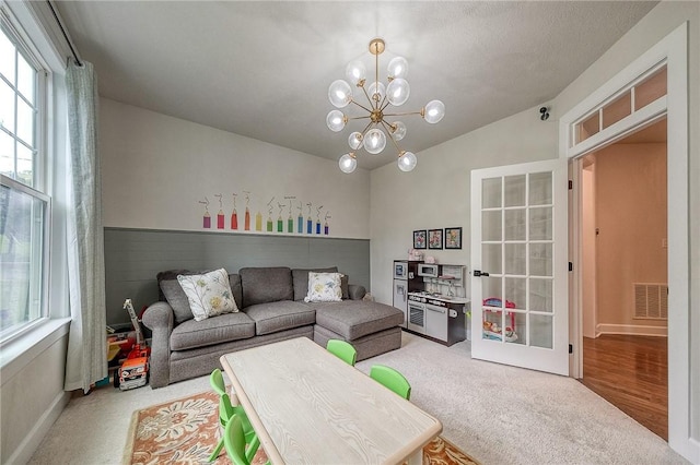 1703 Stevensan, Franklin Park, PA 15143 - living room featuring healthy amount of natural light, light carpet, lofted ceiling, and a chandelier