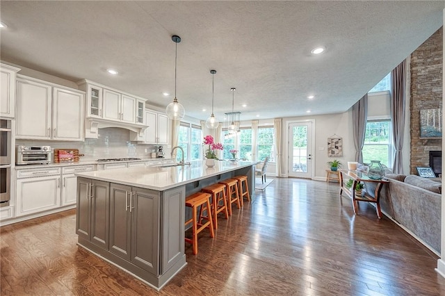 1703 Stevensan, Franklin Park, PA 15143 - kitchen with a sink, dark wood-style floors, light countertops, white cabinets, and a textured ceiling