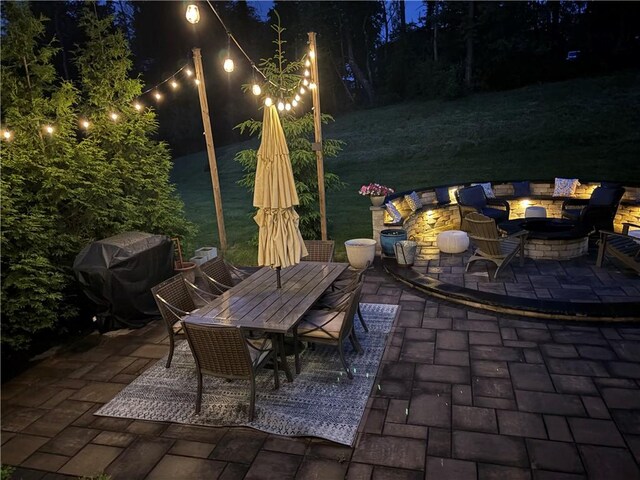 1703 Stevensan, Franklin Park, PA 15143 - patio at night featuring an outdoor fire pit, a patio, outdoor dining space, a yard, and a grill
