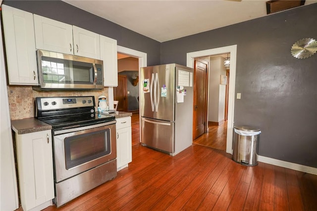 1778 Mercer Rd, Lake Twp, PA 16133 - kitchen with appliances with stainless steel finishes, dark wood finished floors, tasteful backsplash, and dark countertops