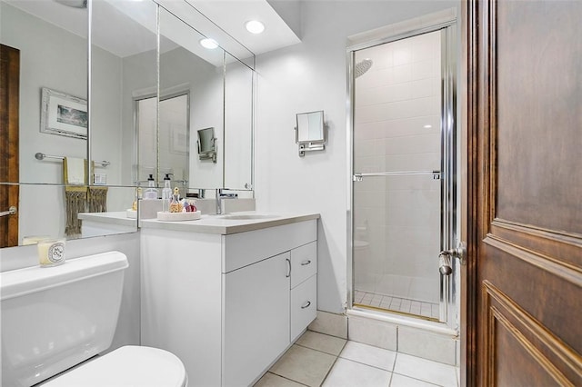 6015 Walnut St Unit 201, Shadyside, PA 15206 - bathroom with toilet, vanity, a shower stall, tile patterned floors, and recessed lighting