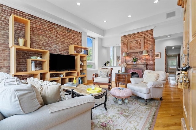 6015 Walnut St Unit 201, Shadyside, PA 15206 - living room with light wood finished floors, brick wall, recessed lighting, and a fireplace