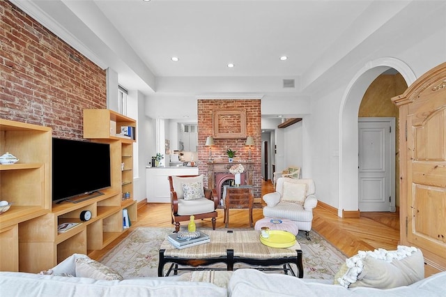 6015 Walnut St Unit 201, Shadyside, PA 15206 - living room featuring arched walkways, brick wall, light wood finished floors, baseboards, and recessed lighting