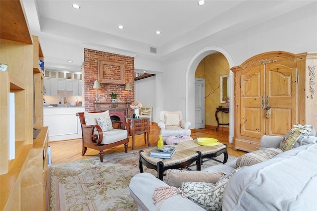 6015 Walnut St Unit 201, Shadyside, PA 15206 - living room featuring arched walkways, recessed lighting, light wood-style flooring, and a tray ceiling