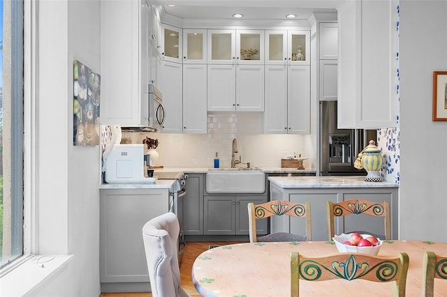 6015 Walnut St Unit 201, Shadyside, PA 15206 - kitchen featuring appliances with stainless steel finishes, a sink, light countertops, backsplash, and recessed lighting