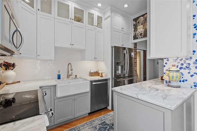 6015 Walnut St Unit 201, Shadyside, PA 15206 - kitchen with appliances with stainless steel finishes, a sink, tasteful backsplash, white cabinetry, and recessed lighting