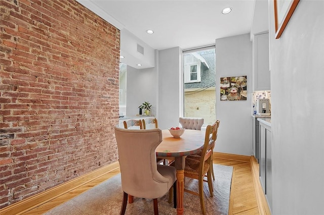 6015 Walnut St Unit 201, Shadyside, PA 15206 - dining area featuring light wood finished floors, recessed lighting, baseboards, and brick wall