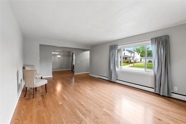 1218 W Ridge Ave, Sharpsville, PA 16150 - unfurnished living room featuring light wood finished floors, baseboards, and baseboard heating