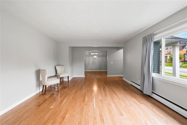 1218 W Ridge Ave, Sharpsville, PA 16150 - unfurnished room featuring plenty of natural light, light wood-style floors, baseboards, and a baseboard radiator