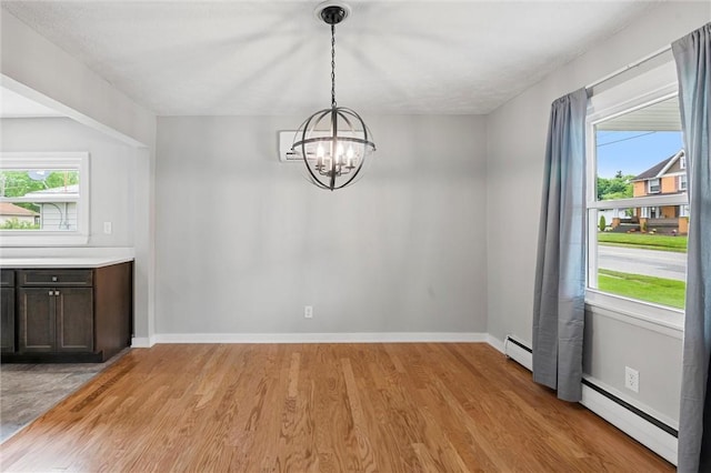 1218 W Ridge Ave, Sharpsville, PA 16150 - unfurnished dining area with a chandelier, baseboard heating, light wood-type flooring, a baseboard heating unit, and baseboards