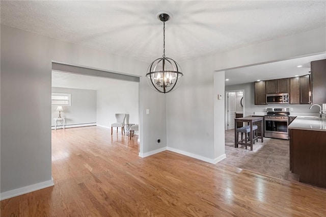 1218 W Ridge Ave, Sharpsville, PA 16150 - dining room with light wood finished floors, baseboards, a chandelier, and a baseboard radiator