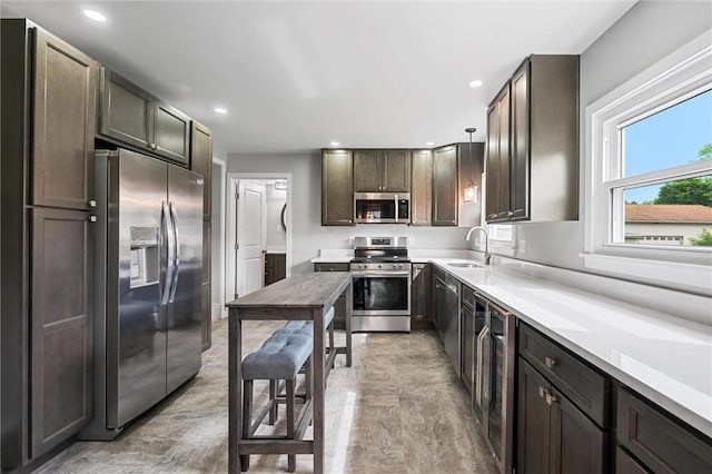 1218 W Ridge Ave, Sharpsville, PA 16150 - kitchen with stainless steel appliances, beverage cooler, a sink, recessed lighting, and light countertops
