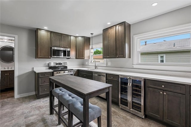 1218 W Ridge Ave, Sharpsville, PA 16150 - kitchen featuring wine cooler, stainless steel appliances, a sink, dark brown cabinetry, and recessed lighting