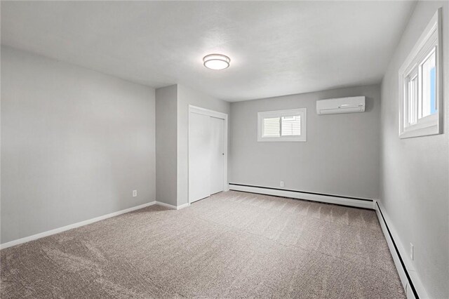 1218 W Ridge Ave, Sharpsville, PA 16150 - unfurnished bedroom featuring a wall unit AC, baseboard heating, carpet flooring, and a closet