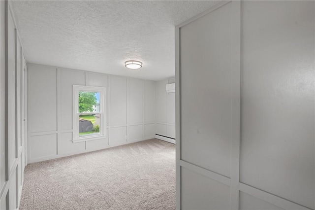1218 W Ridge Ave, Sharpsville, PA 16150 - carpeted spare room with a textured ceiling, baseboard heating, and a decorative wall