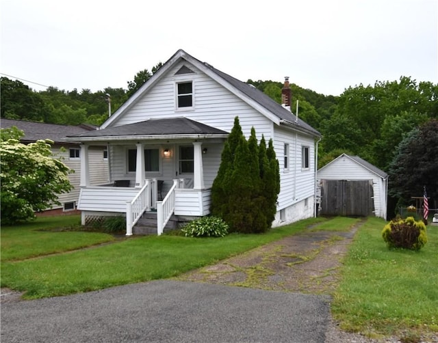 117 Oregon, Vandergrift Wml, PA 15690 - bungalow-style house with a porch, an outbuilding, a front lawn, a chimney, and driveway