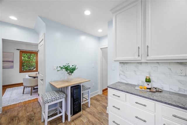 61 Ehle Ave, Kennedy Twp, PA 15108 - kitchen with decorative backsplash, wood finished floors, beverage cooler, white cabinets, and recessed lighting