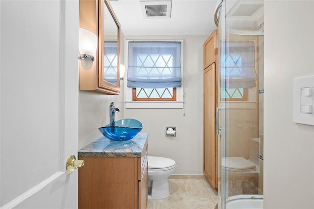 61 Ehle Ave, Kennedy Twp, PA 15108 - bathroom with toilet, vanity, a shower stall, baseboards, and tile patterned flooring