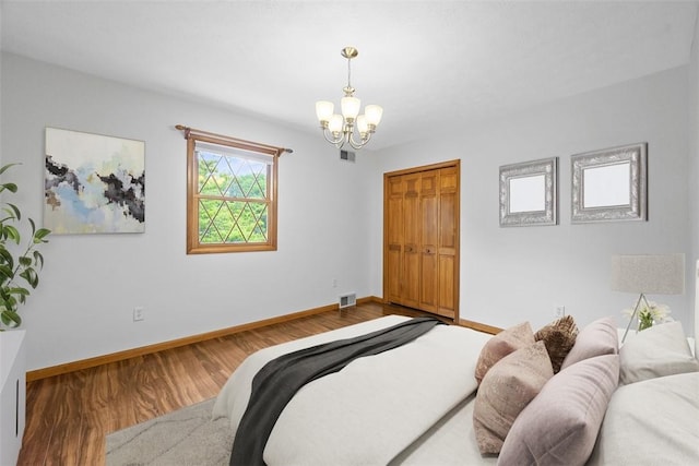 61 Ehle Ave, Kennedy Twp, PA 15108 - bedroom with a chandelier, baseboards, wood finished floors, and a closet