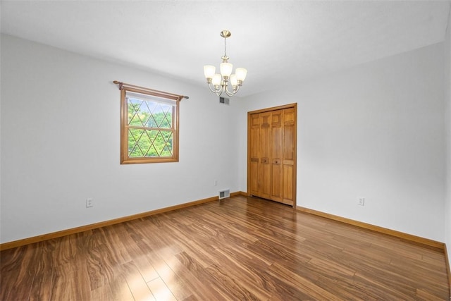 61 Ehle Ave, Kennedy Twp, PA 15108 - spare room with a chandelier, wood finished floors, and baseboards