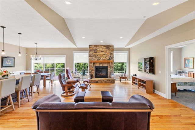 209 Lucca Ln, Upper St Clair, PA 15241 - living room with lofted ceiling, light wood-type flooring, a stone fireplace, a chandelier, and recessed lighting