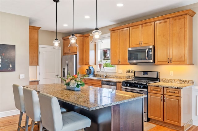 209 Lucca Ln, Upper St Clair, PA 15241 - kitchen with stainless steel appliances, a sink, a kitchen island, light wood finished floors, and recessed lighting