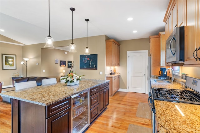 209 Lucca Ln, Upper St Clair, PA 15241 - kitchen featuring appliances with stainless steel finishes, beverage cooler, a sink, light wood finished floors, and a center island