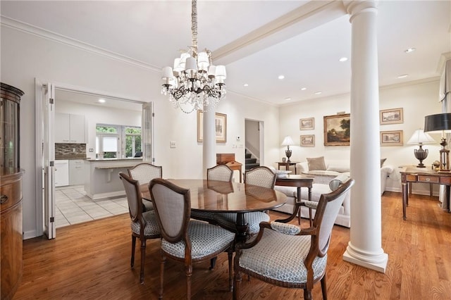 202 N Woodland Rd, Shadyside, PA 15232 - dining area with decorative columns, ornamental molding, recessed lighting, stairway, and light wood-style flooring