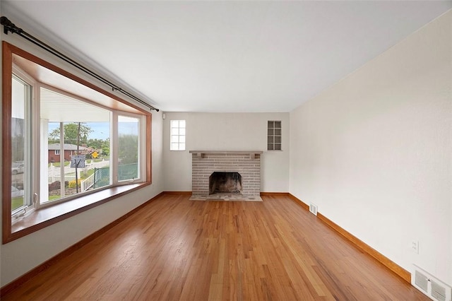 3353 Mcroberts Rd, Castle Shannon, PA 15234 - unfurnished living room with light wood-style flooring, a fireplace, and baseboards