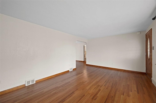 3353 Mcroberts Rd, Castle Shannon, PA 15234 - empty room with arched walkways, wood finished floors, and baseboards