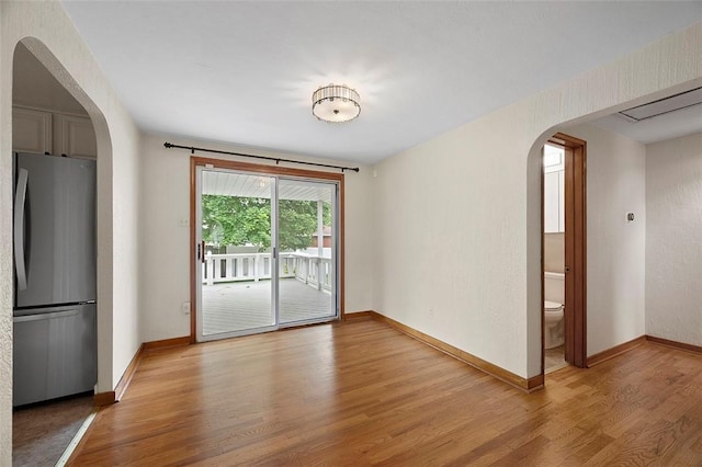 3353 Mcroberts Rd, Castle Shannon, PA 15234 - empty room featuring arched walkways, light wood finished floors, and baseboards