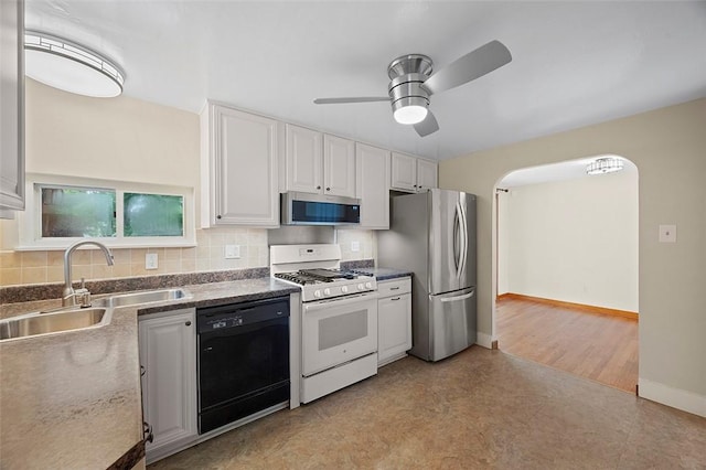 3353 Mcroberts Rd, Castle Shannon, PA 15234 - kitchen with appliances with stainless steel finishes, a sink, ceiling fan, white cabinets, and backsplash