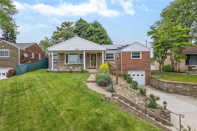 3353 Mcroberts Rd, Castle Shannon, PA 15234 - view of front facade with concrete driveway, an attached garage, roof mounted solar panels, stone siding, and a porch